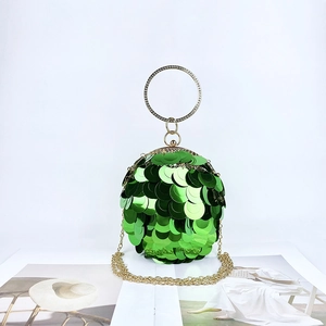 Detail of green sequin evening bag with gold ring handle and metallic chain strap