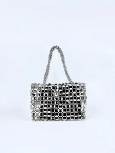 Detailed view of silver metallic woven handbag featuring hollow mesh and bead handles