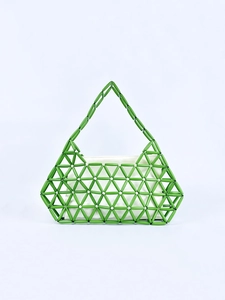 Green beaded tote bag with geometric hollow design and white fabric liner bag