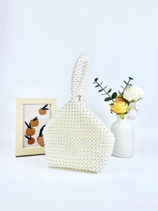Handmade beaded pearl handbag with unique geometric shape and elegant top handle