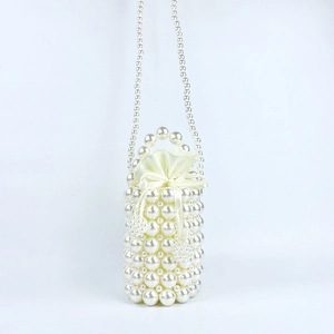 Detail of handmade pearl beaded bucket bag with satin drawstring liner and handle