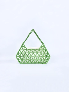Detail of green beaded geometric woven handbag with white canvas inner liner pouch