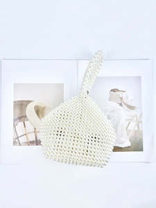Handmade pearl beaded handbag featuring unique triangular design and glossy finish