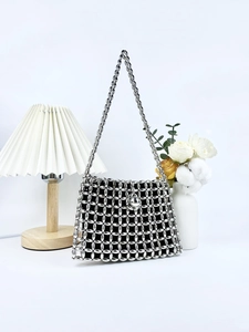 Silver beaded mesh shoulder bag with a large metallic ball clasp and a slim chain strap