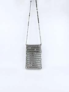 Detailed macro of silver handmade beaded mini bag with metallic paillette texture