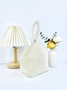Elegant handmade white pearl beaded handbag with unique triangular shape and circular handle