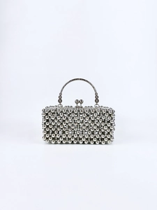Close-up of silver metal beaded evening bag with decorative kiss-lock and metal handle