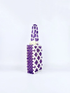 Detail of purple and white beaded handbag with crystals, pearls, and satin lining