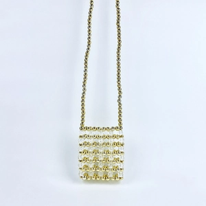 Detailed macro view of handmade mini beaded bag with gold pearls and crystal stones