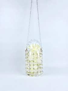 Detail of beaded bucket bag with transparent acrylic pearls and satin drawstring pouch