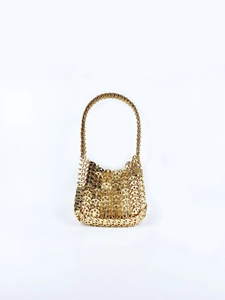 Detailed view of handmade gold metallic sequin chainmail texture on a luxury handbag