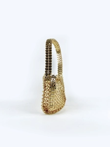 Detailed macro view of the golden chainmail sequins on a vintage style handmade handbag