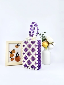 Handmade purple and white beaded handbag with pearl accents and a silk ribbon bow