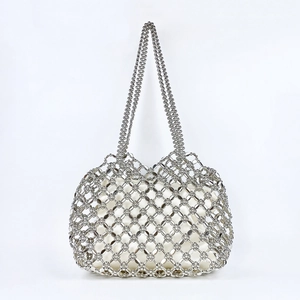 Detailed close-up of silver beaded woven handbag with white satin inner lining bag