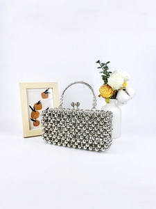 Elegant silver beaded metal evening clutch with circular handle for party and formal events