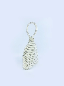 Detail of handmade pearl beaded handbag with unique water drop shape and round handle