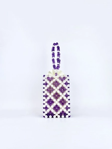 Detail of beaded floral pattern bag with purple crystal beads and white pearls