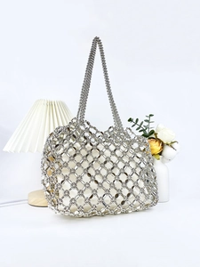 Silver hollow beaded tote bag with inner pouch shown in a minimalist home setting