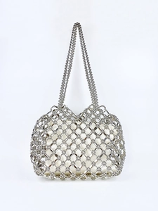 Detail of silver beaded hollow mesh handbag featuring a white silk lining and dual handles
