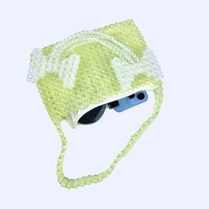 Interior view of beaded shoulder bag showing storage for phone and sunglasses