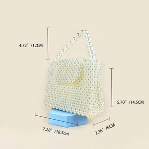 Detail view of handmade pearl box bag showing dimensions of width 18.5cm and height 14.5cm