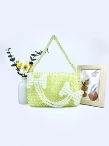 Handmade light green acrylic beaded shoulder bag with white bow accent and transparent beads