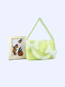 Handmade light green acrylic beaded bag with white bow pattern and top handle