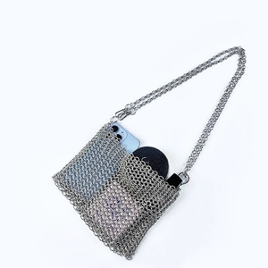 Detail of silver chainmail crossbody bag showing interior space for phone and lipstick