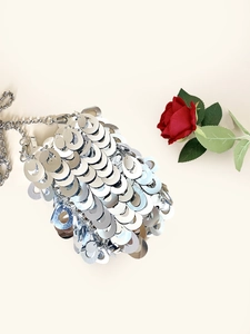 Detail view of silver drop sequins on handmade evening bag with metal chain strap