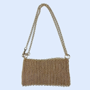 Detail of handmade gold metal chainmail bag featuring a metallic sequin scale design