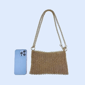 Detail of handmade gold sequin woven bag with metallic fish scale texture and chain strap