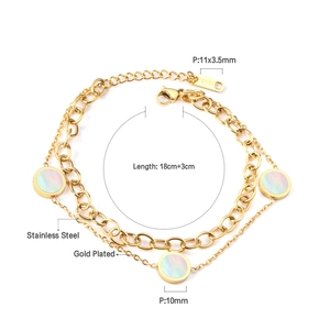 Detail view of double-layer gold-plated bracelet with 10mm shell pendants and lobster clasp