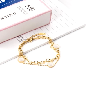 Macro shot of 18K gold plated clasp with 18KGP engraving on double-layered bracelet