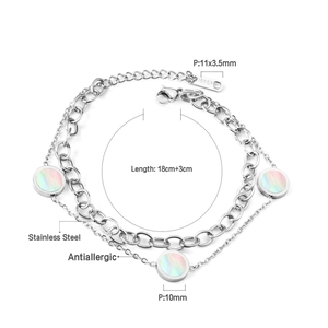 Detail view of double-layer stainless steel bracelet showing shell charms and sizing