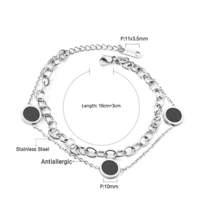 Detail of double-layer stainless steel bracelet with black charms and 18KGP mark