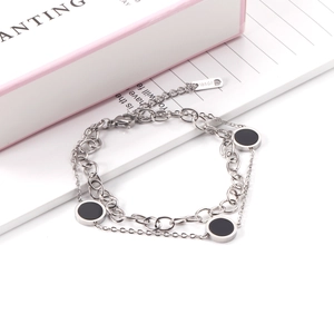 Double-layer silver stainless steel bracelet featuring black round enamel charms and 18KGP tag