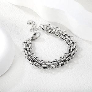 Detailed macro view of silver stainless steel Cuban chain bracelet with lobster clasp