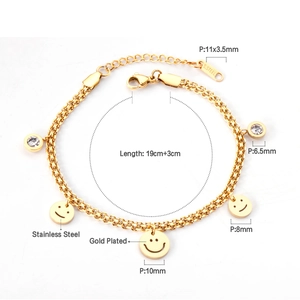 Detailed view of gold double-layer bracelet with smiley faces and crystal charms