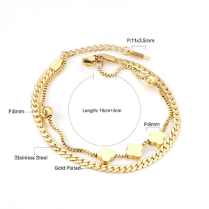 Detail view of gold-plated double-layer stainless steel bracelet with clover and bead