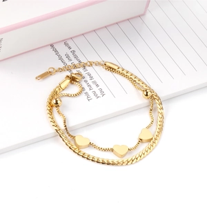 Detail of 18K gold-plated double-layer bracelet with heart pendants and adjustable clasp