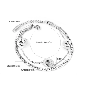 Detail of silver double-layer stainless steel bracelet with roman numeral ring pendants