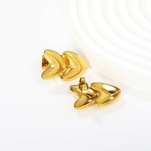 Detailed close-up of 18k gold-plated geometric heart earrings on a minimalist white display