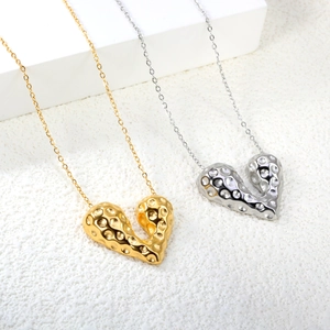 Hammered heart pendant necklace in gold and silver finish with textured steel surface