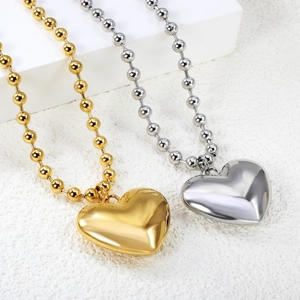 Minimalist stainless steel heart pendant necklaces in polished gold and silver finishes