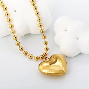 Detailed view of a 3D hollow heart pendant necklace in polished 18K gold plated steel