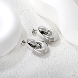 Modern interlocking double loop silver earrings with polished finish and butterfly backs