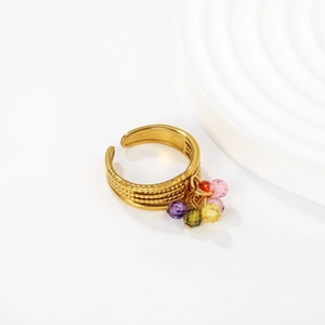 Close-up of golden adjustable ring with multi-row texture and colorful bead charms