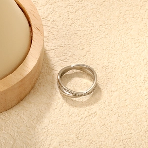 Silver criss-cross ring with pavé cubic zirconia set in high-polish stainless steel