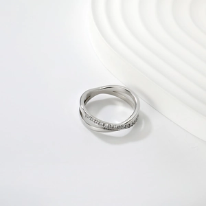 Detailed view of silver cross ring with sparkling zircon inlays and polished finish