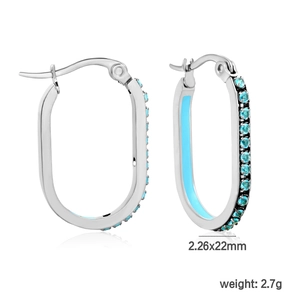 Detail of oval stainless steel hoop earrings with teal crystals and blue enamel inlay
